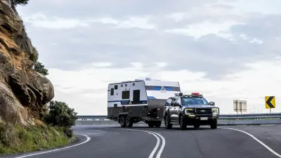 a car and trailer in a road